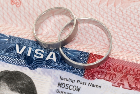 Newlyweds rings on a US visa close-up | The Modi Law Firm, PLLC