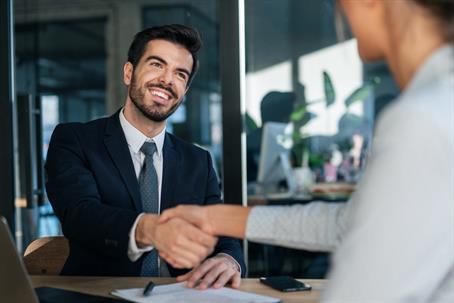 business people shaking hands in an office