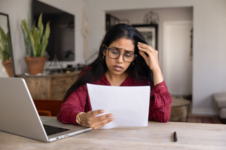 stressed woman reading a letter